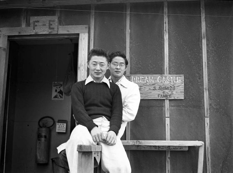 Two young men sitting in front of the Shimizu barrack