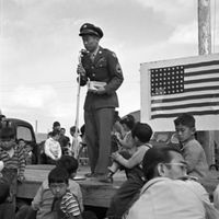 Sergeant Ben Kuroki speaking from an outdoor stage