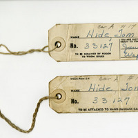 Luggage tags used by Tom Hide.